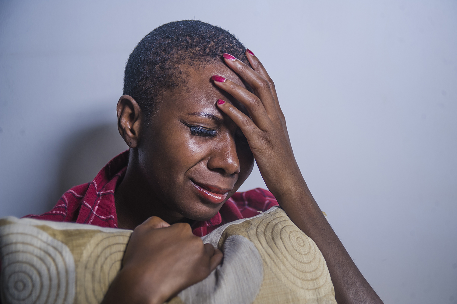 lifestyle indoors portrait of young sad and depressed black afro